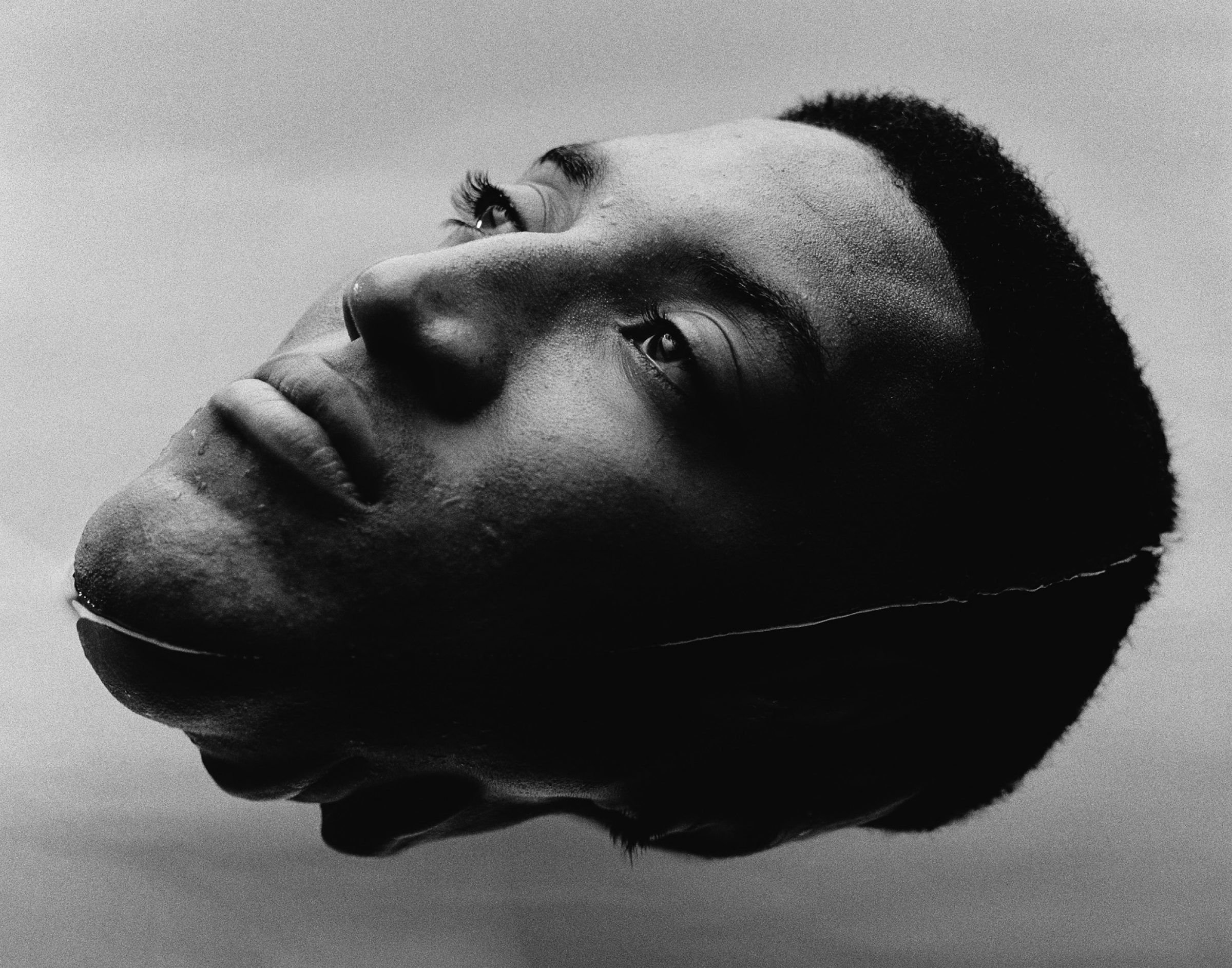 b&w image of  man floating in water